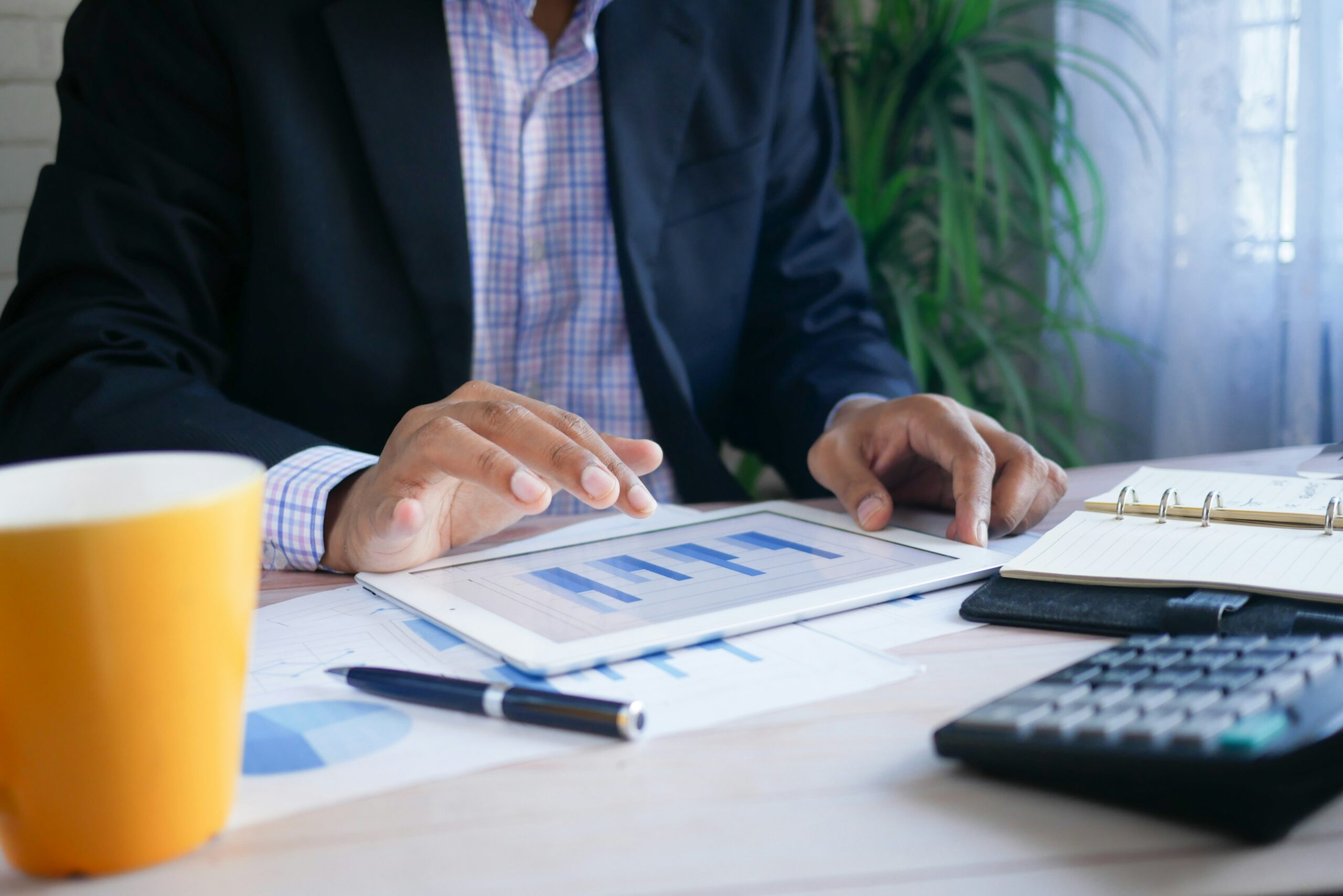 Business manager reviewing compliance documents and insurance risk information