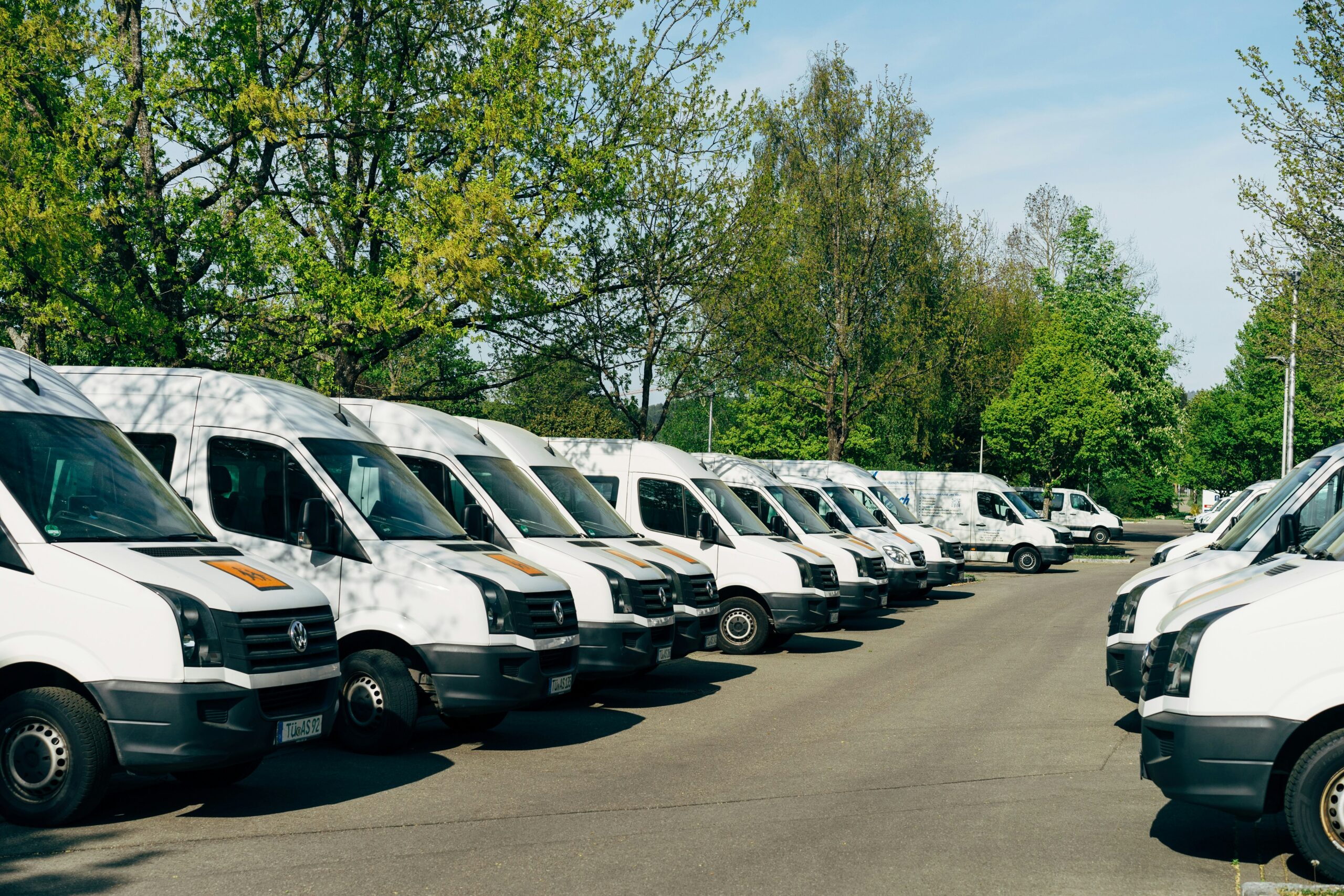 Commercial vehicles parked together as a business fleet at a depot