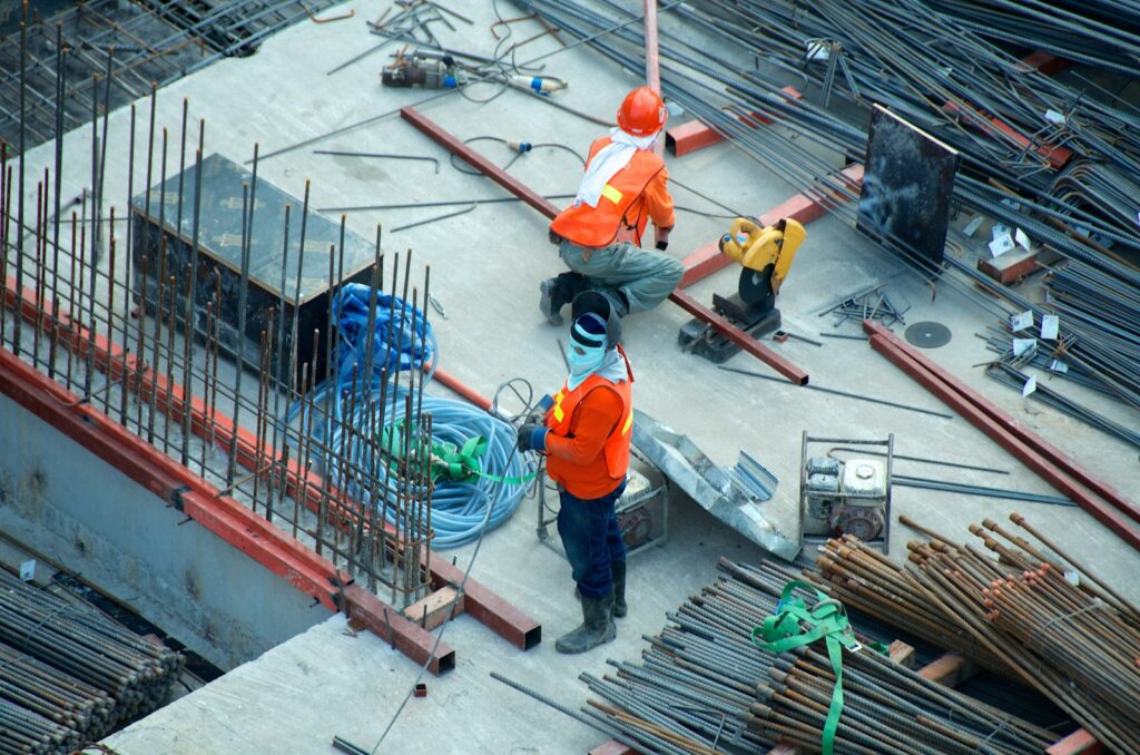 Experienced Australian builders reviewing construction plans and insurance risks