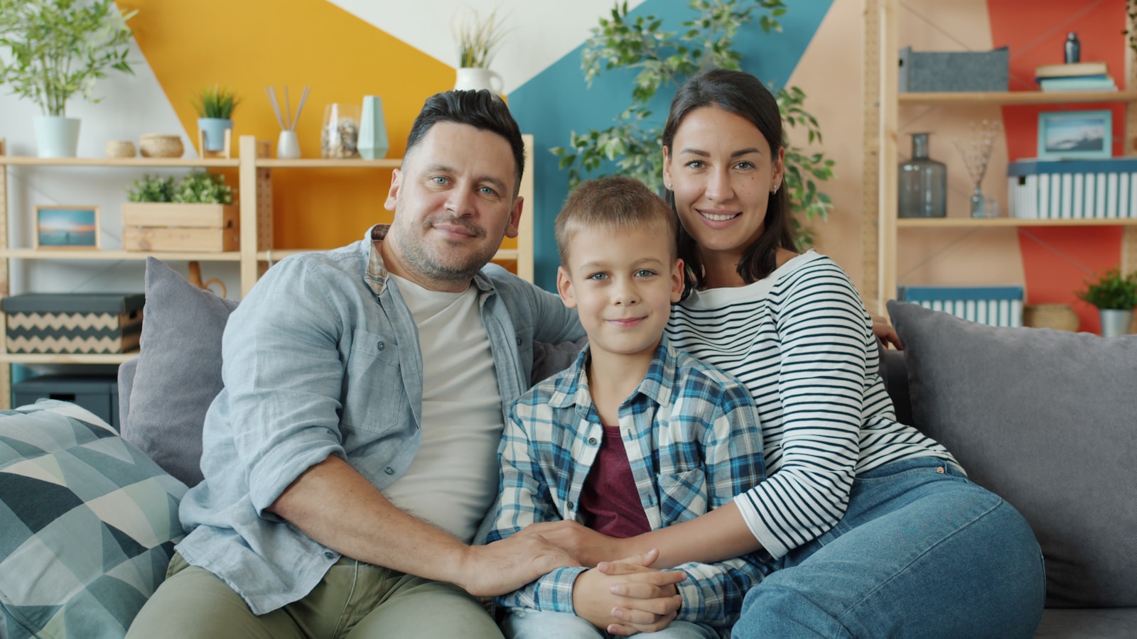 Mother, father and child together at home representing family protection through life insurance in Australia