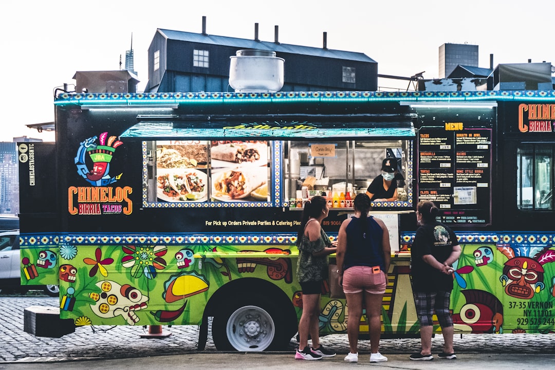 Customers ordering food from a mobile food truck service window