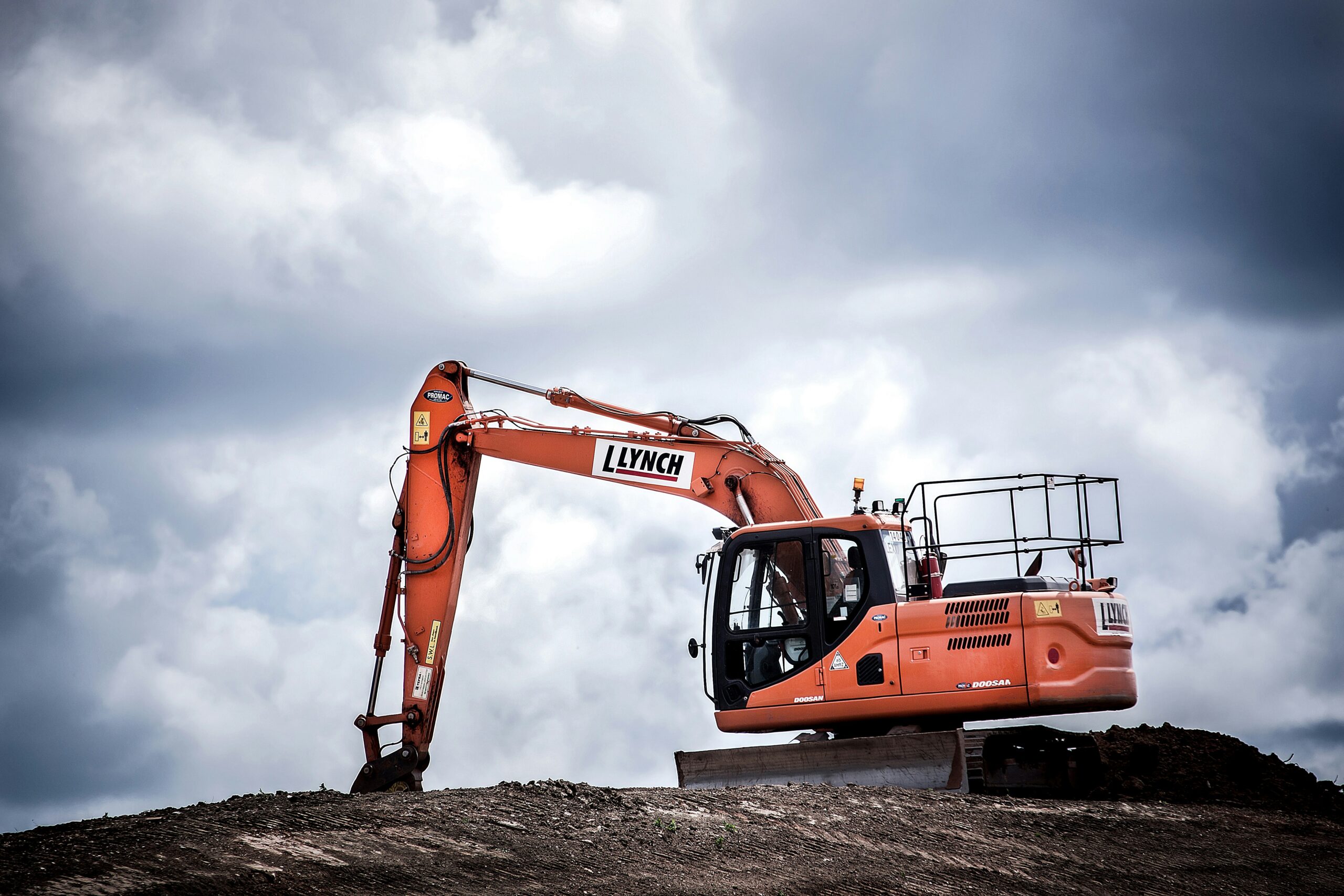 Orange excavator operating on a construction site