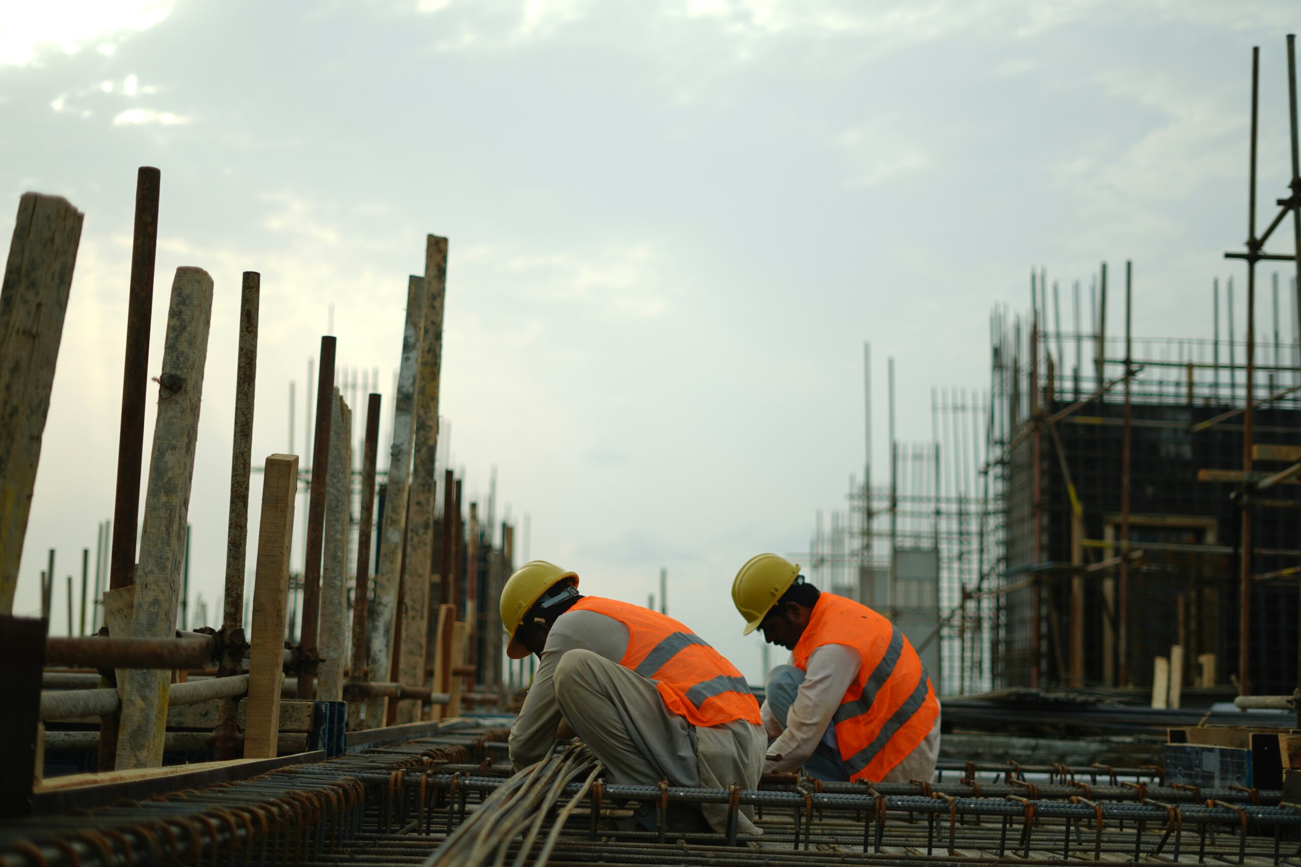 Construction workers wearing safety equipment on a worksite